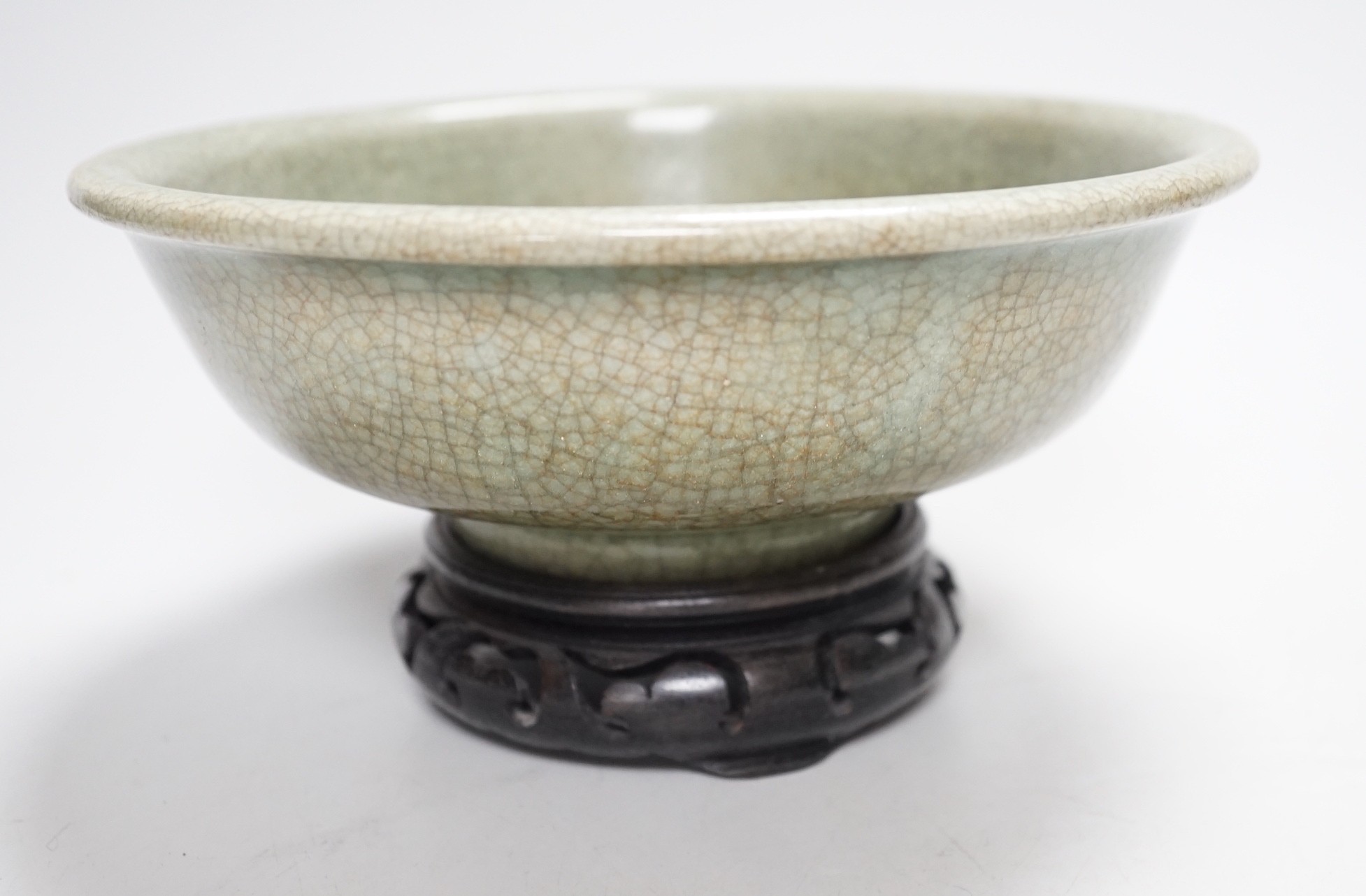 A Chinese Guan type green crackle glaze bowl, early 20th century 19cm diameter, on hardwood stand